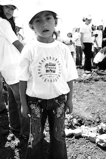 A camper with a T-shirt that says 'peace' in English, Arabic and Hebrew