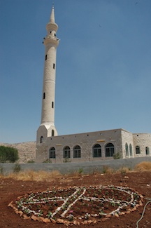 Unique minaret with a double peak representing a peace sign.