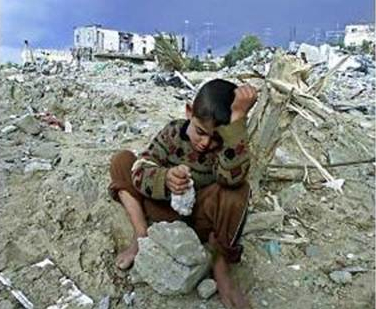 image of boy in rubble of his Gaza home